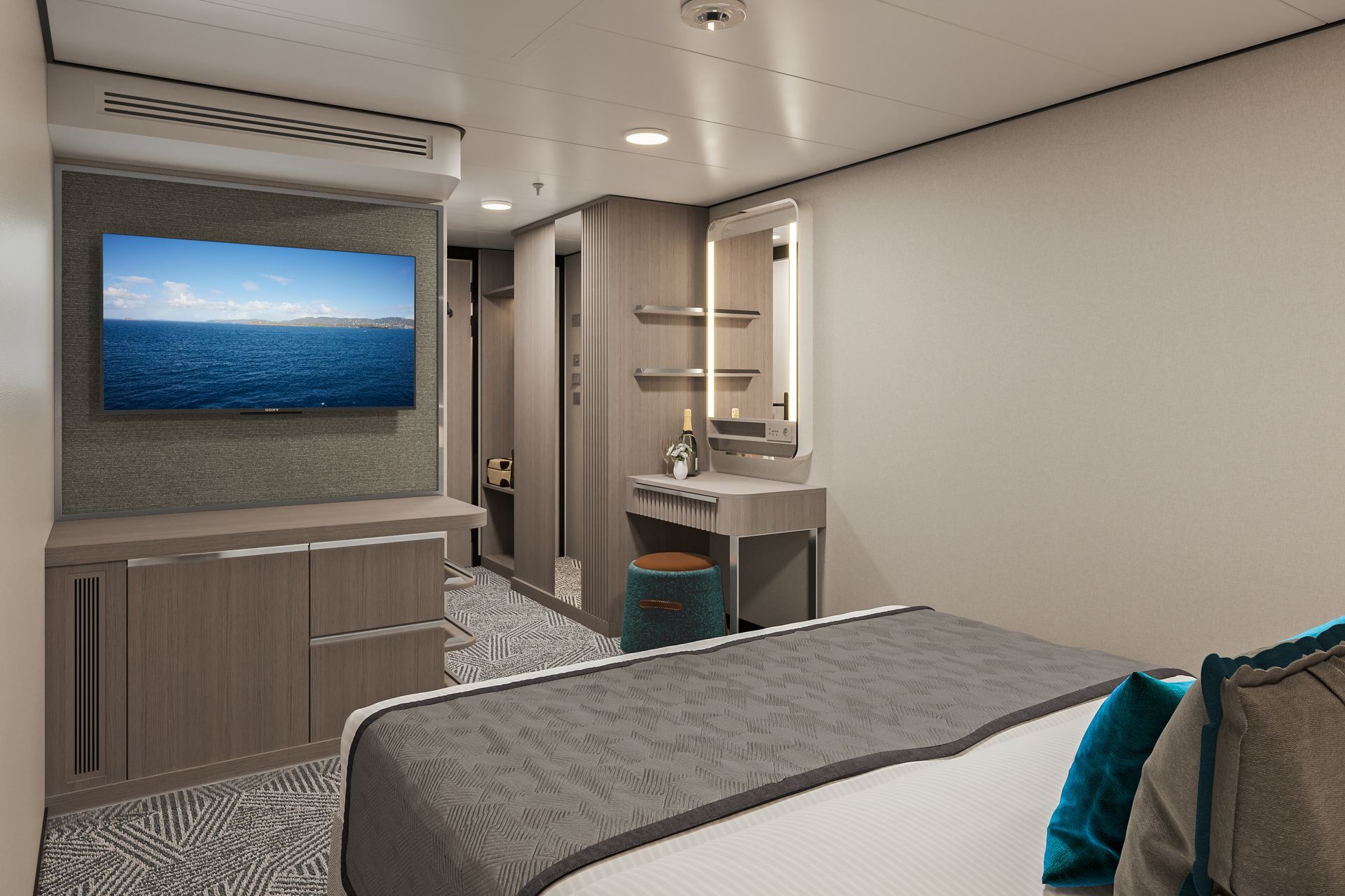 A cruise ship cabin with a bed, a wall-mounted television, a desk with a mirror and a stool, and neutral decor.