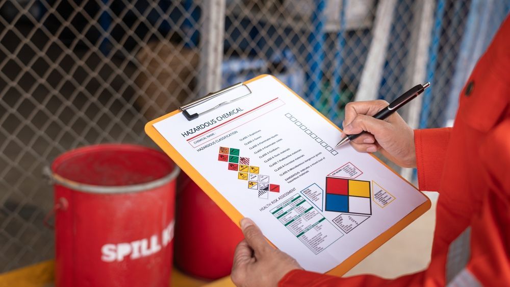 Person Holds a Clipboard With a Safety Checklist — Safe Industries Group in Manning Valley, NSW