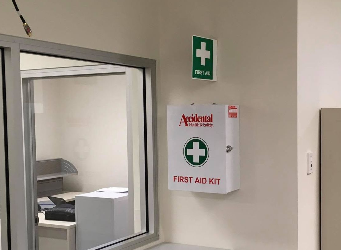 Open red first-aid kit bag with organized medical supplies and bottles inside — Safe Industries Group in Woodrising, NSW