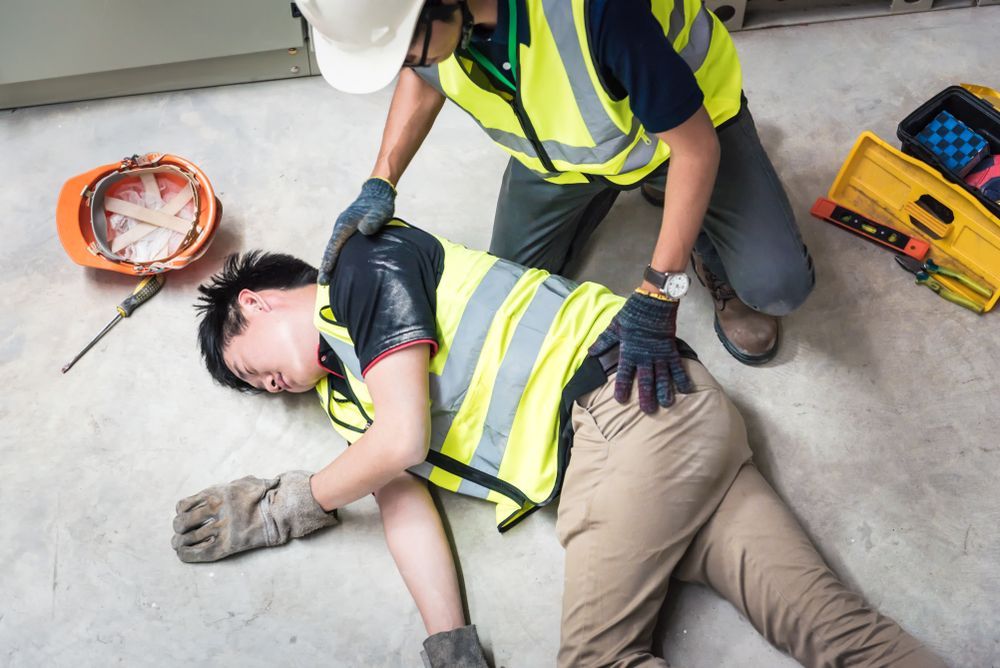 Two Workers in Safety Vests Performing CPR — Safe Industries Group in Cessnock, NSW