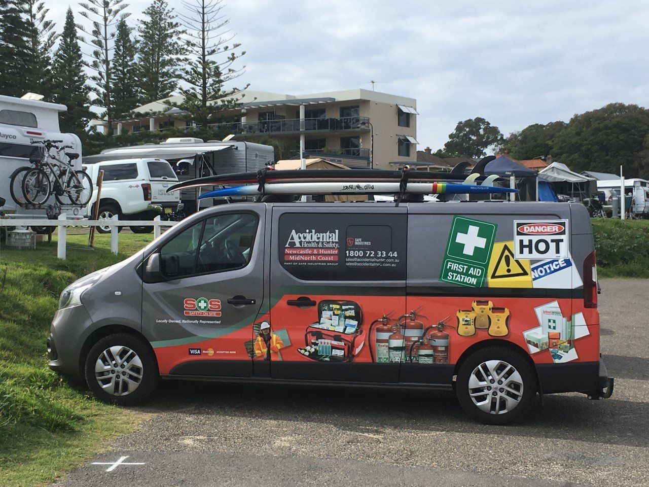 Red Fire Alarm Mounted on a Glass Wall — Safe Industries Group in Woodrising, NSW