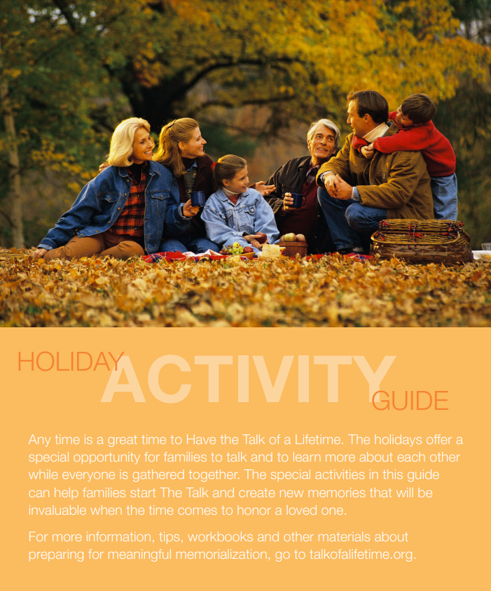 A family is sitting on a pile of leaves in a park.