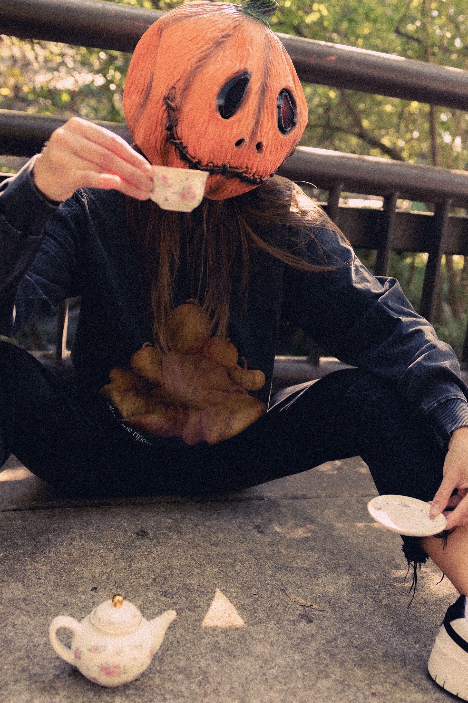 woman in a pumpkin head modeling a fall pumpkin shirt