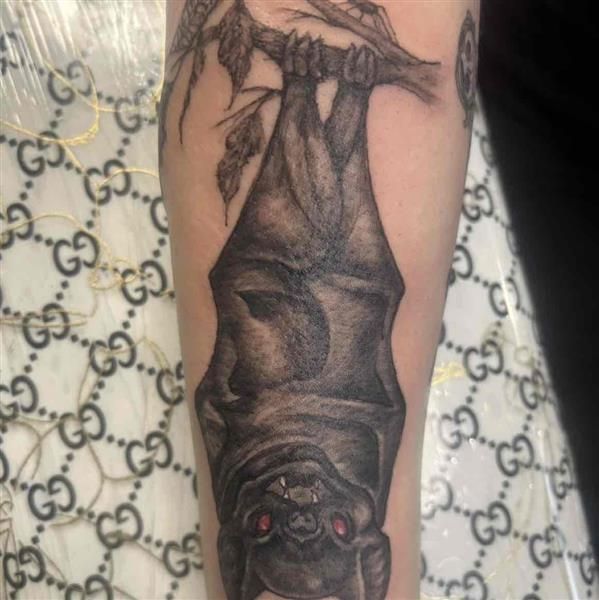 A black and grey realism tattoo portrait with detailed shading and depth.