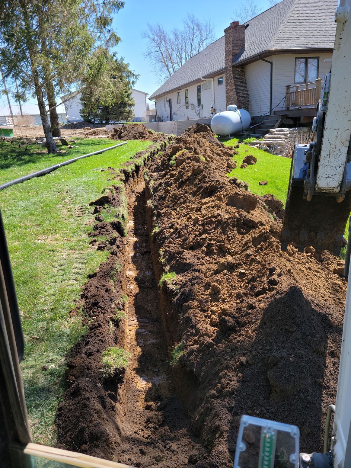 a large pile of dirt is sitting in front of a house