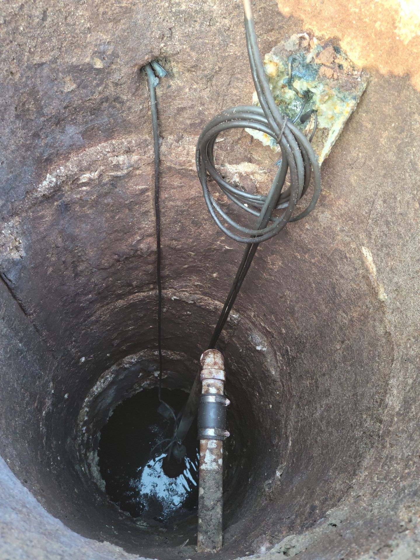 a hole in the ground with a shovel sticking out of it