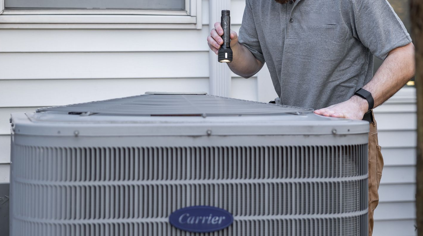 Plumber working on a gas heating system in a residential property.
