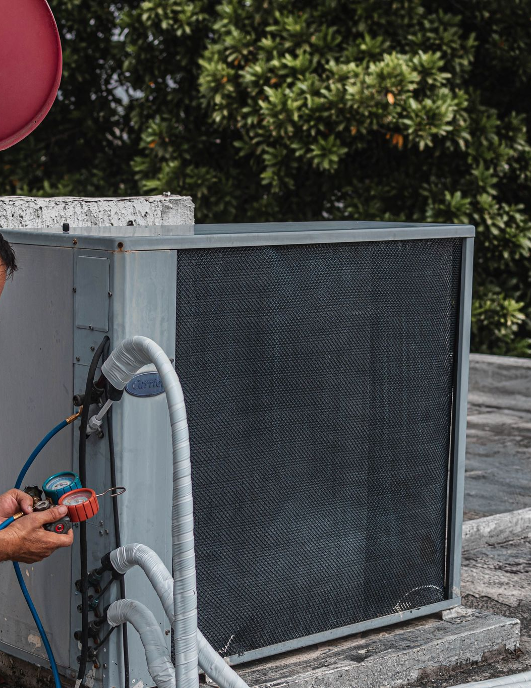 Plumber working on a gas heating system in a residential property.