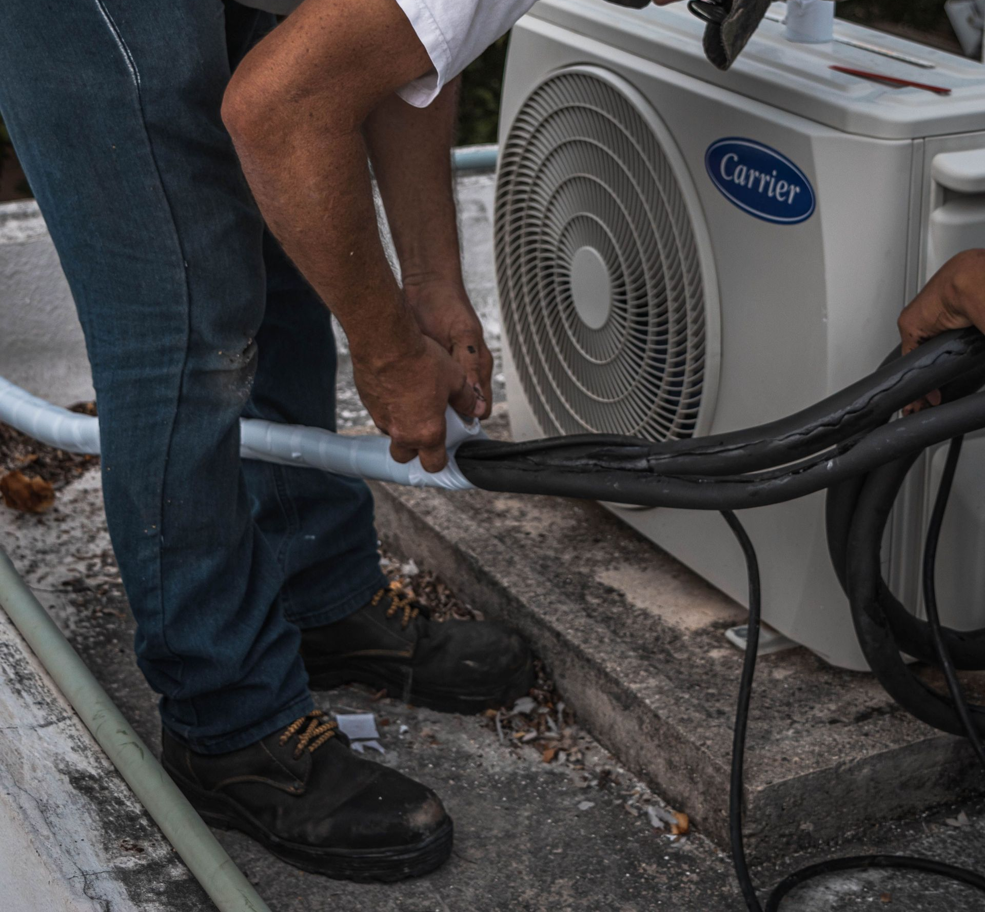 Plumber working on a gas heating system in a residential property.