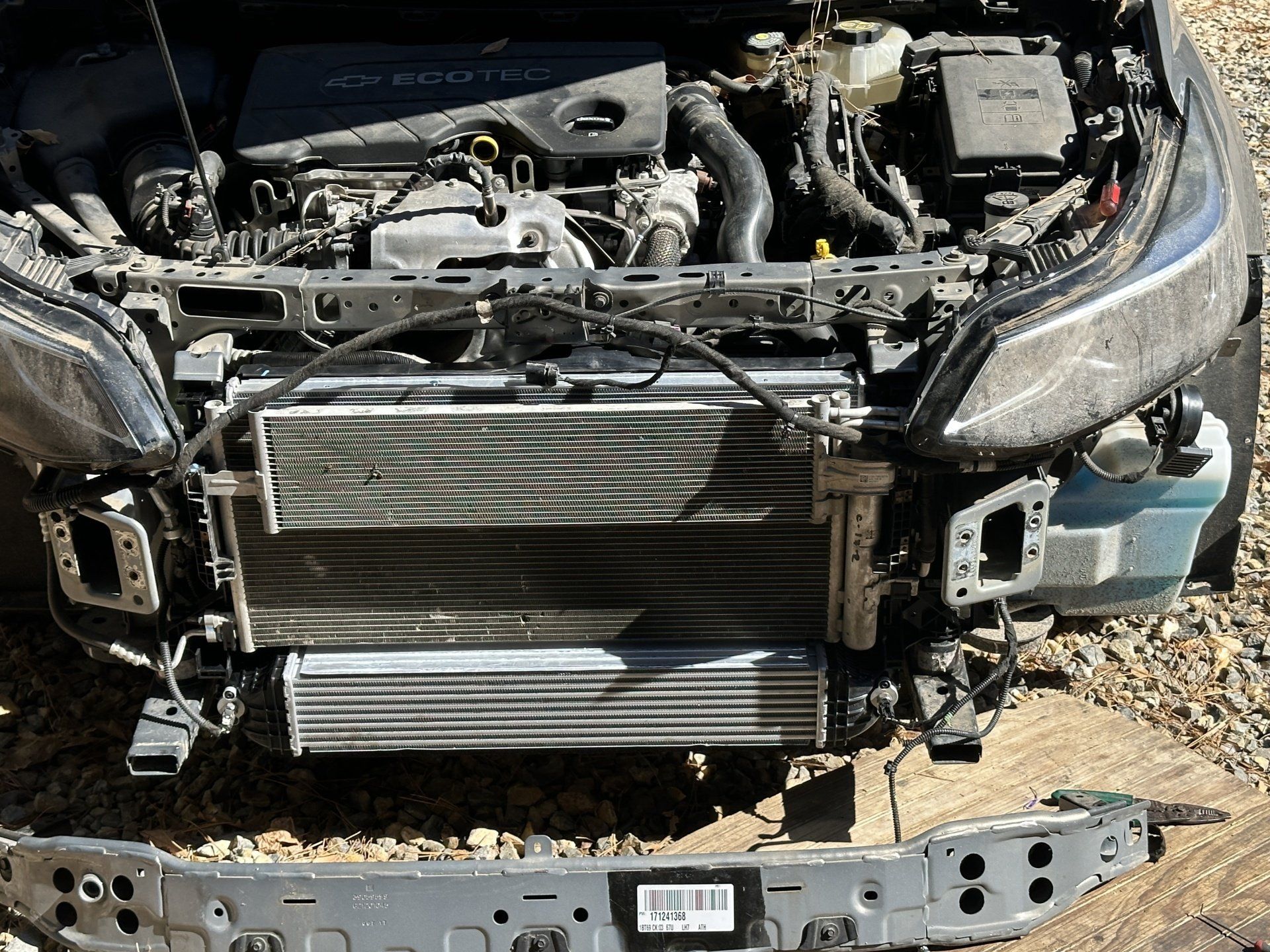 A car with the hood open and the radiator removed