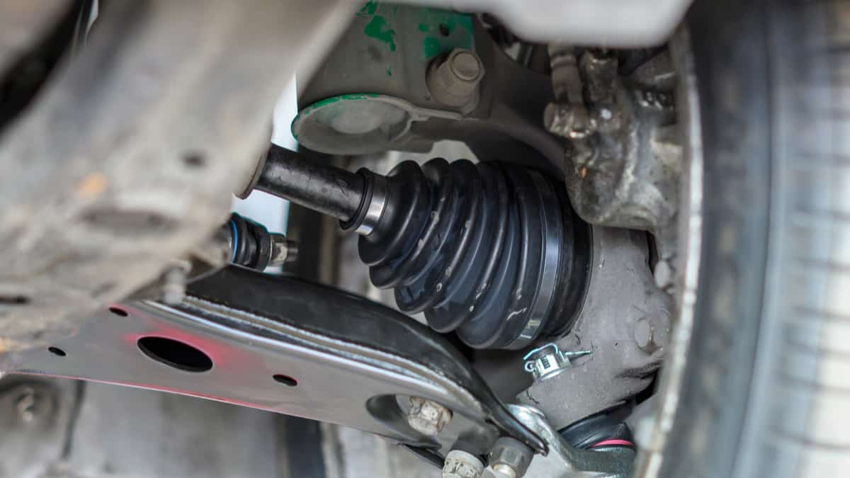 Undercarriage of a vehicle, showing the CV axle with a rubber boot.