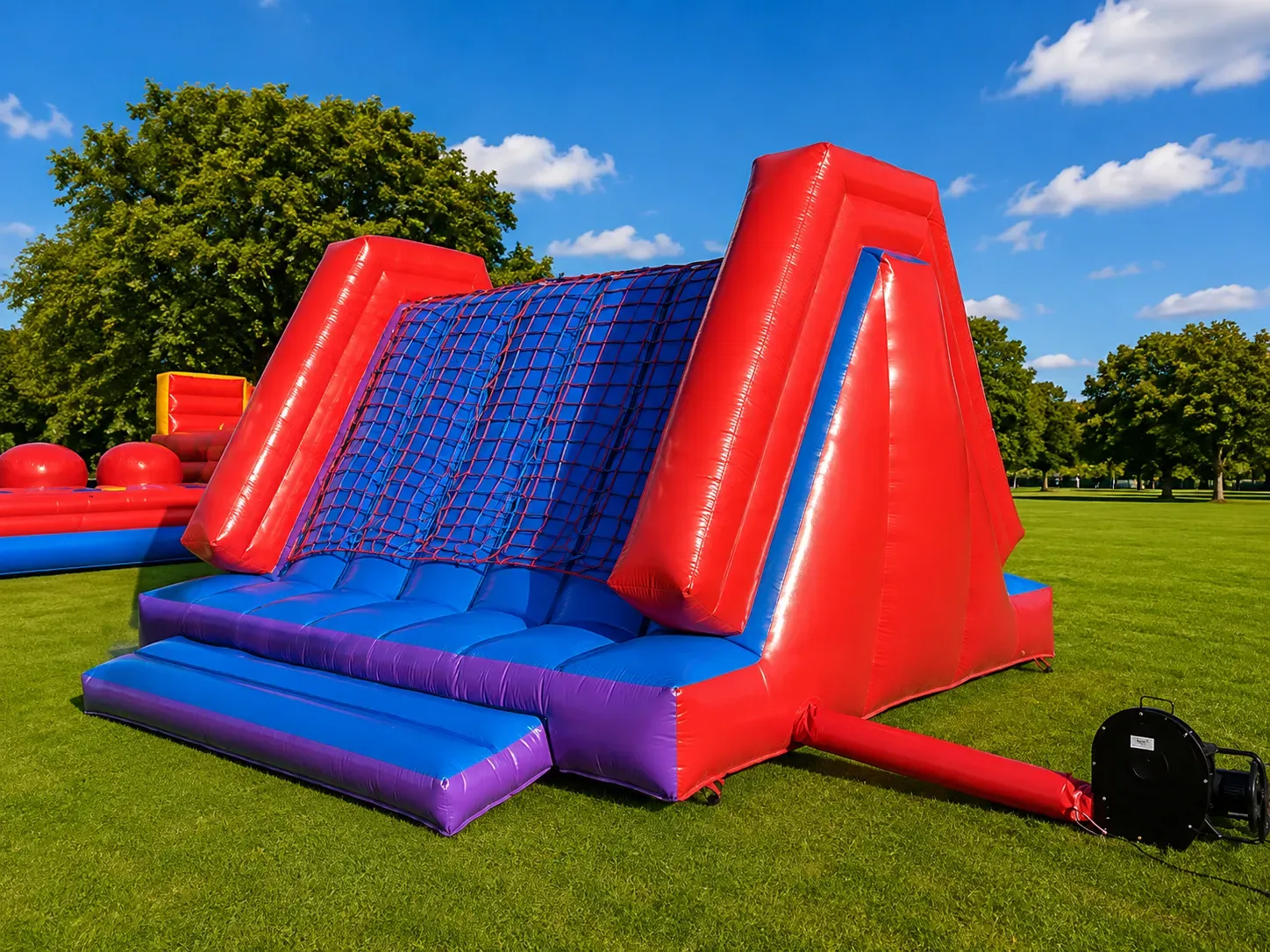 Participants racing through Wipeout & Warrior Race inflatable obstacle courses
