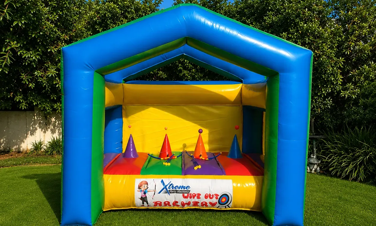 Participant aiming through an inflatable shooting tunnel at an outdoor event