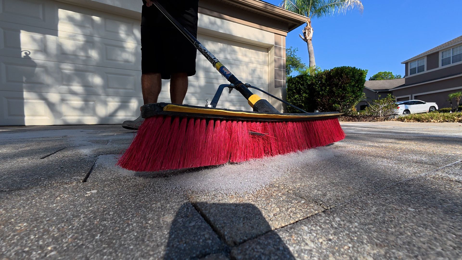 Applying silica sand to pavers