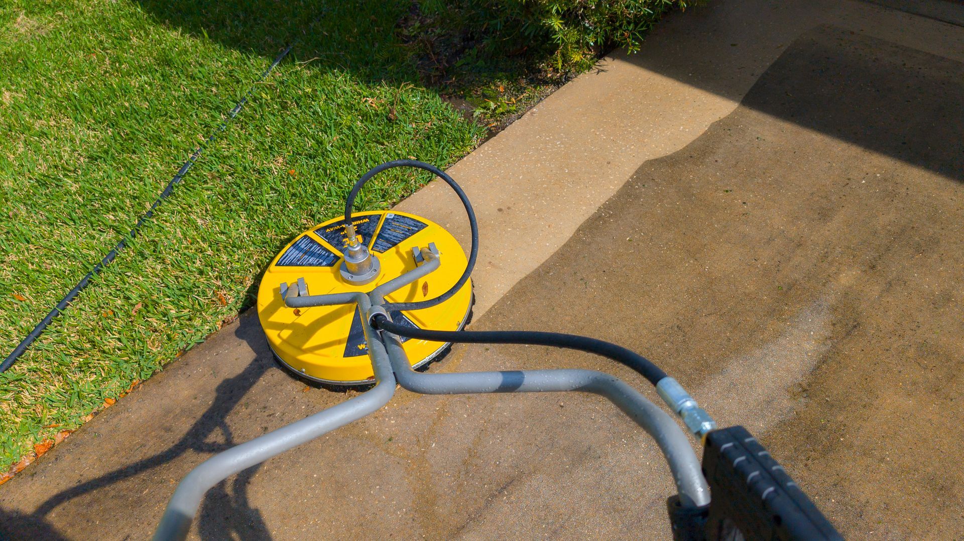 Pressure washing dirty driveway