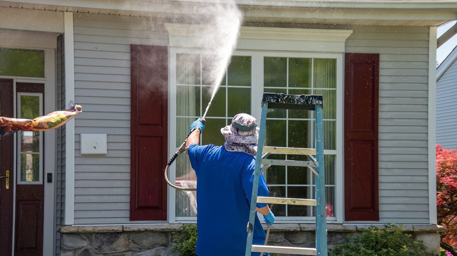 Man washing house
