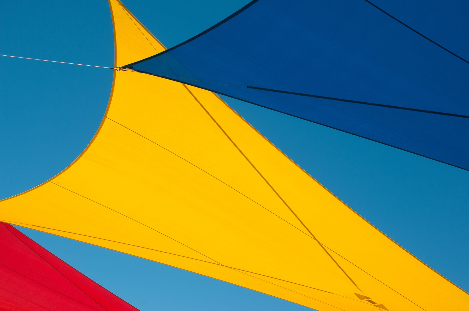 View of Colourful Shade Sails Against the Blue Sky on a Clear Day