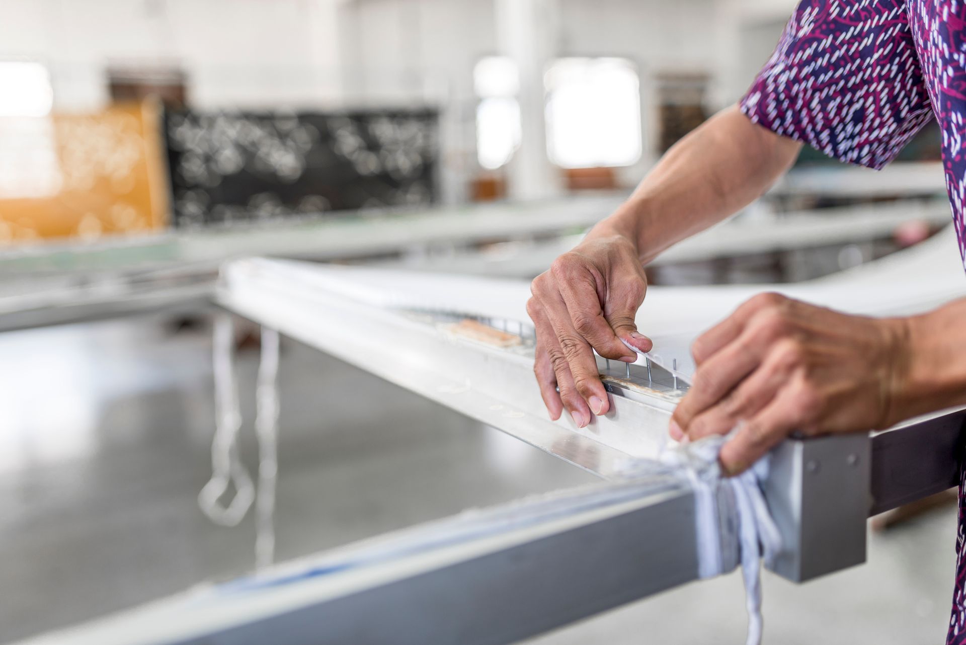 Worker repairing shade sails
