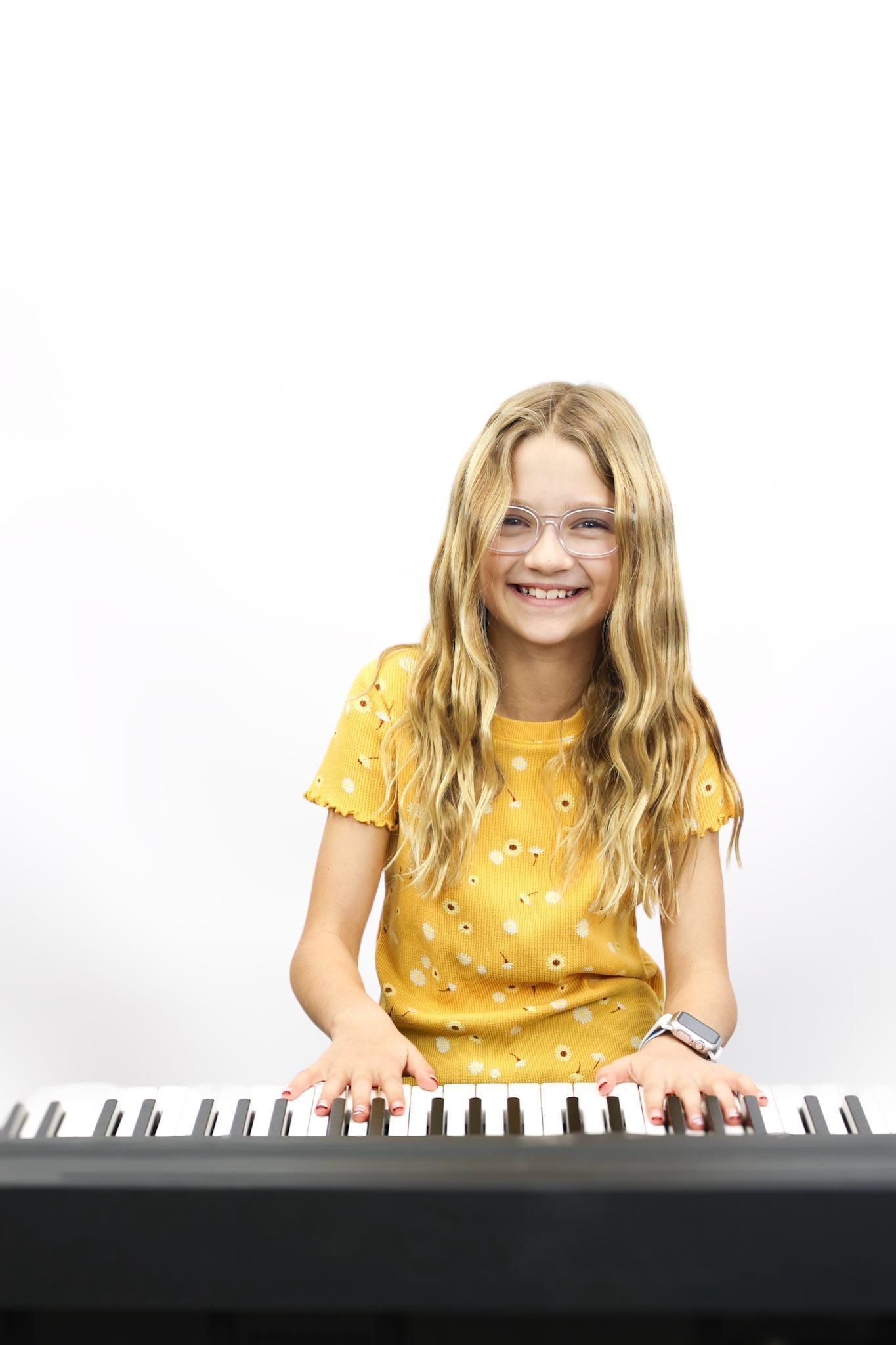 A young boy is playing a piano in a garage.