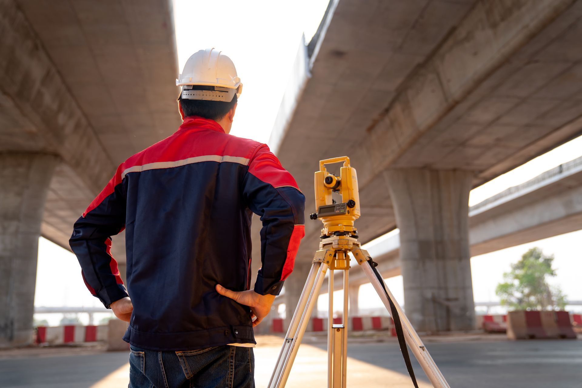 Man Surveying in Front of A Bridge — Clarkston, MI — Kieft Engineering