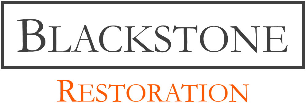 Blackstone Restoration logo with lighthouse icon and black and orange text