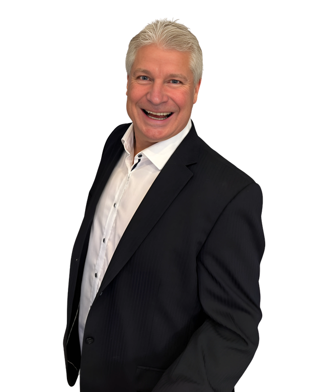 A man in a suit and white shirt is smiling for the camera.