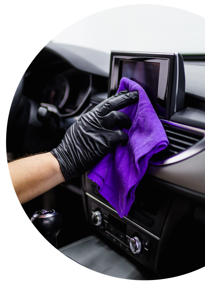 A man cleaning car interior, car detailing (or valeting) concept. Selective focus.
