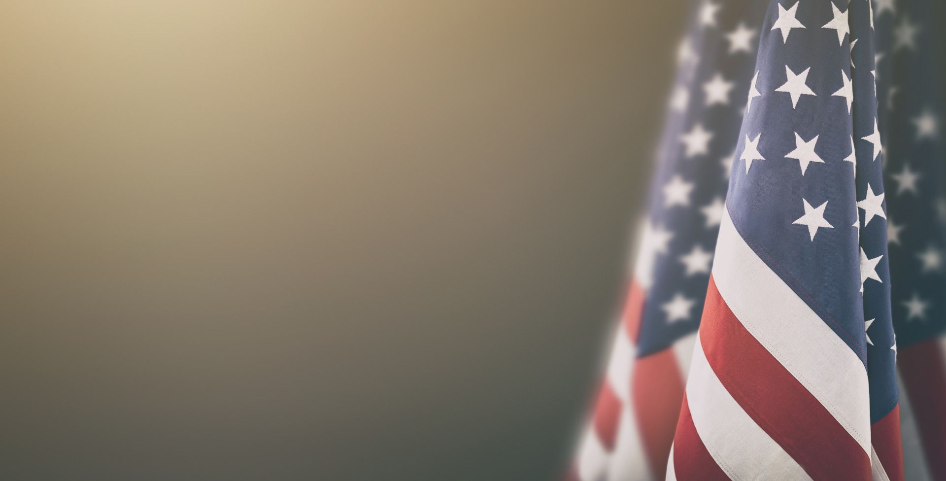 A close-up of a rumpled American flag with its blue star field and red and white stripes.