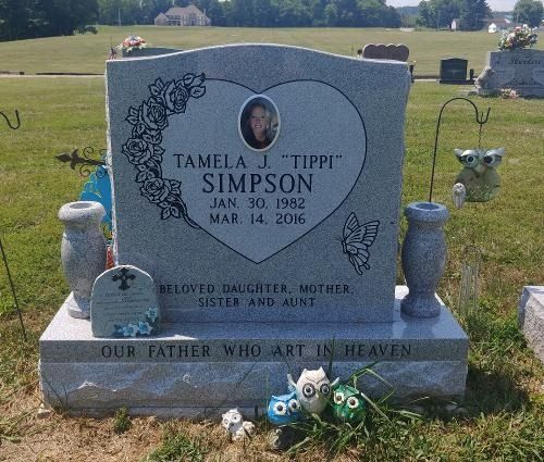 A gray stone headstone inscribed 