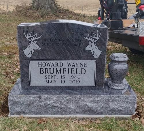 A gray granite headstone for Howard Wayne Brumfield, engraved with two deer heads and dates Sept. 15, 1940 – Mar. 19, 2019.