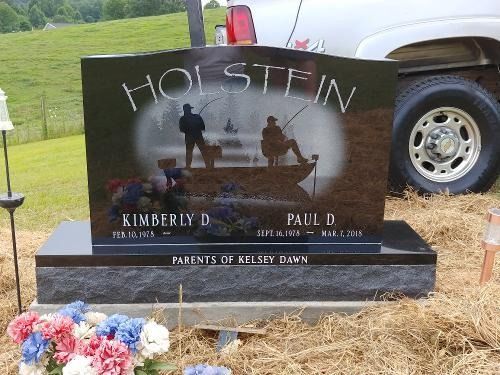 A black headstone engraved with 