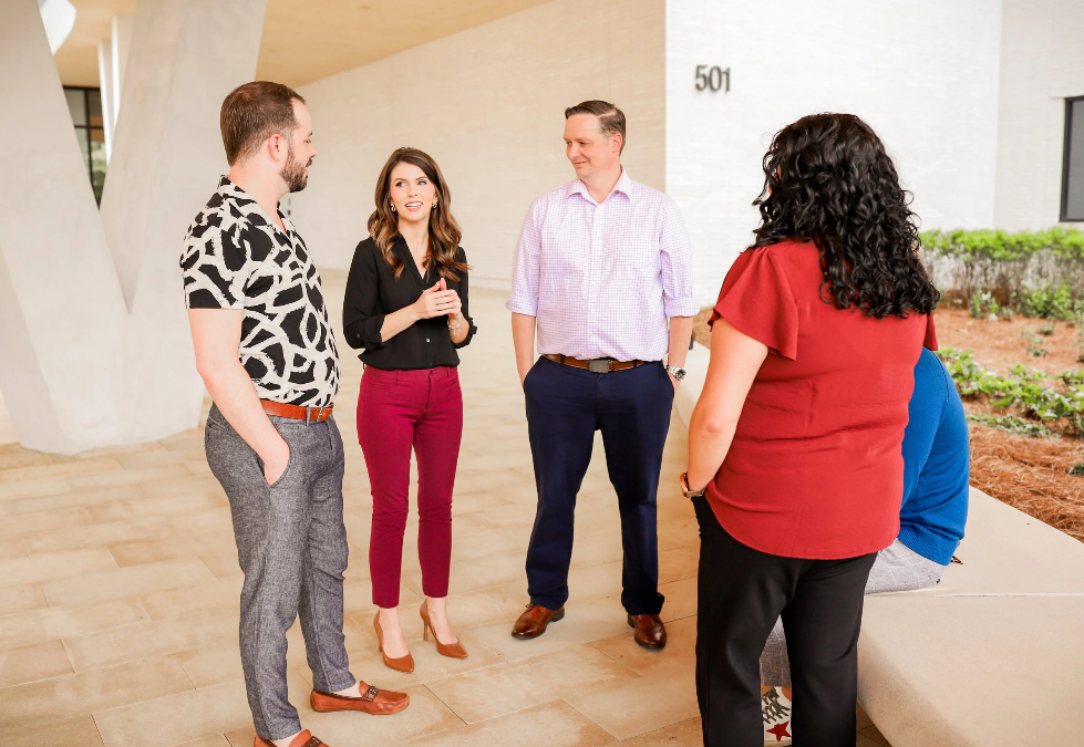 Flexion point team standing and talking.