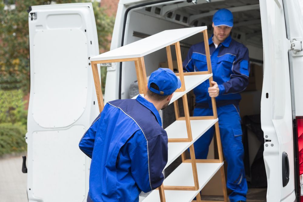 Two Men Are Loading Shelves Into a Van — Town & Country Removals In Laurieton, NSW