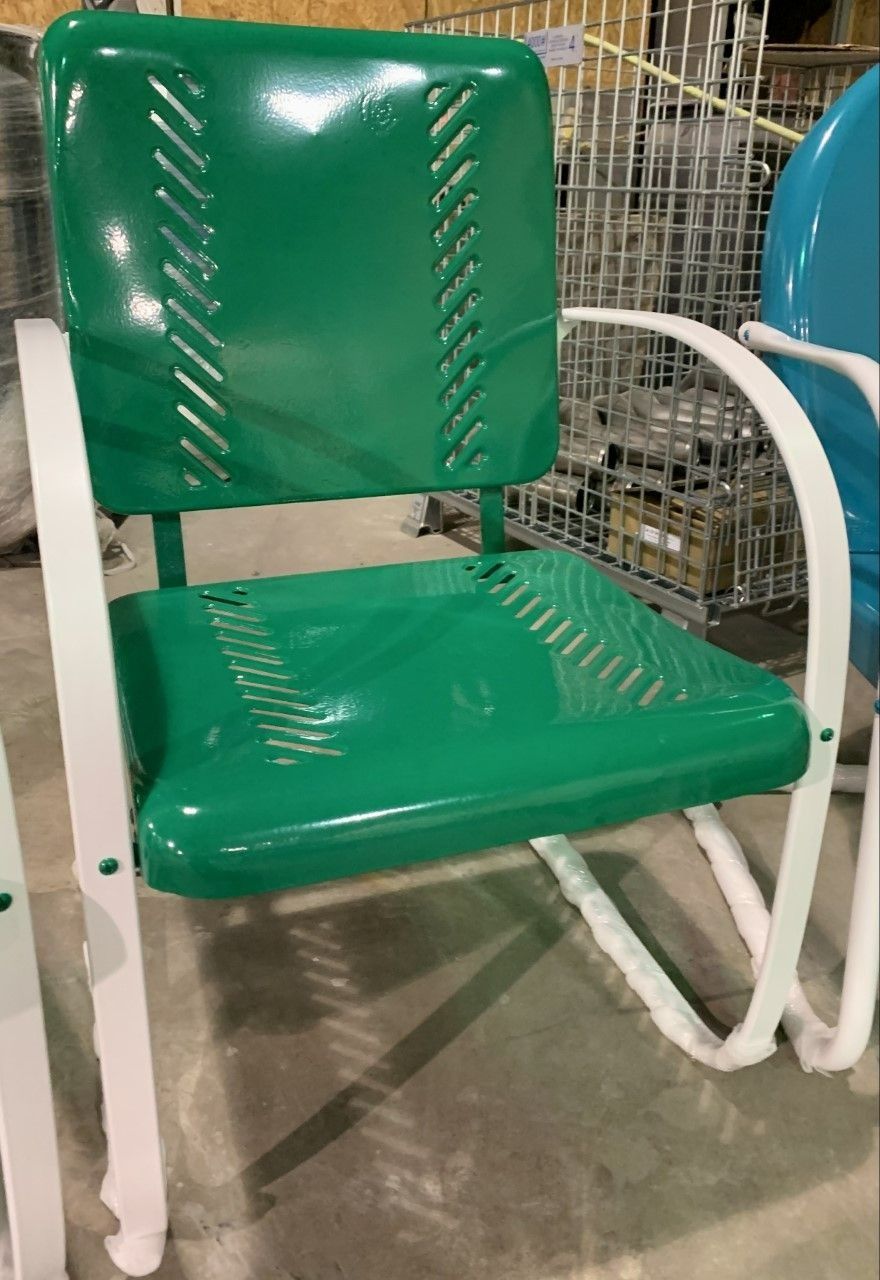 Green and white vintage metal lawn chair with slotted seat and back.