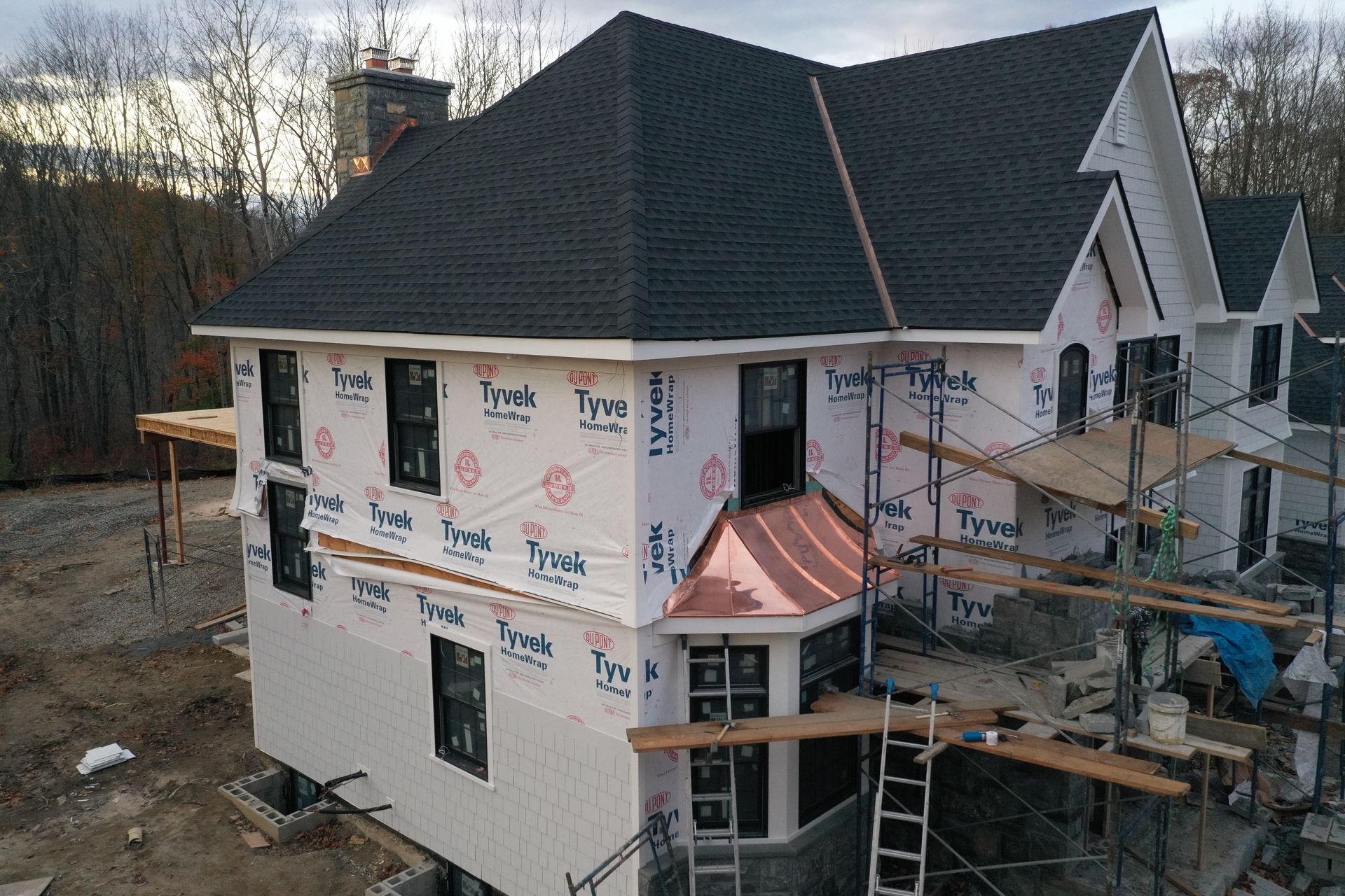 A large house getting new siding installed