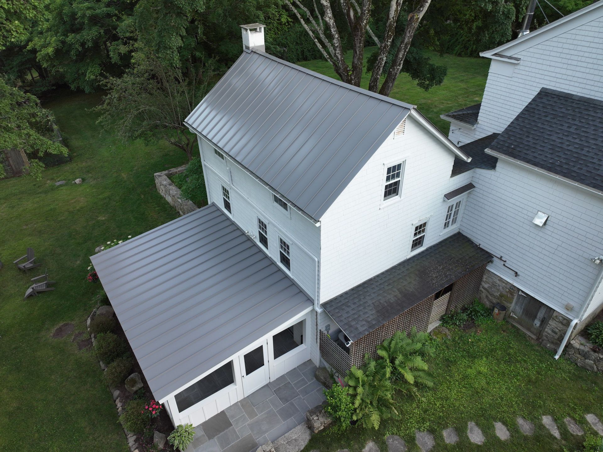 White home with gray metal roof installation