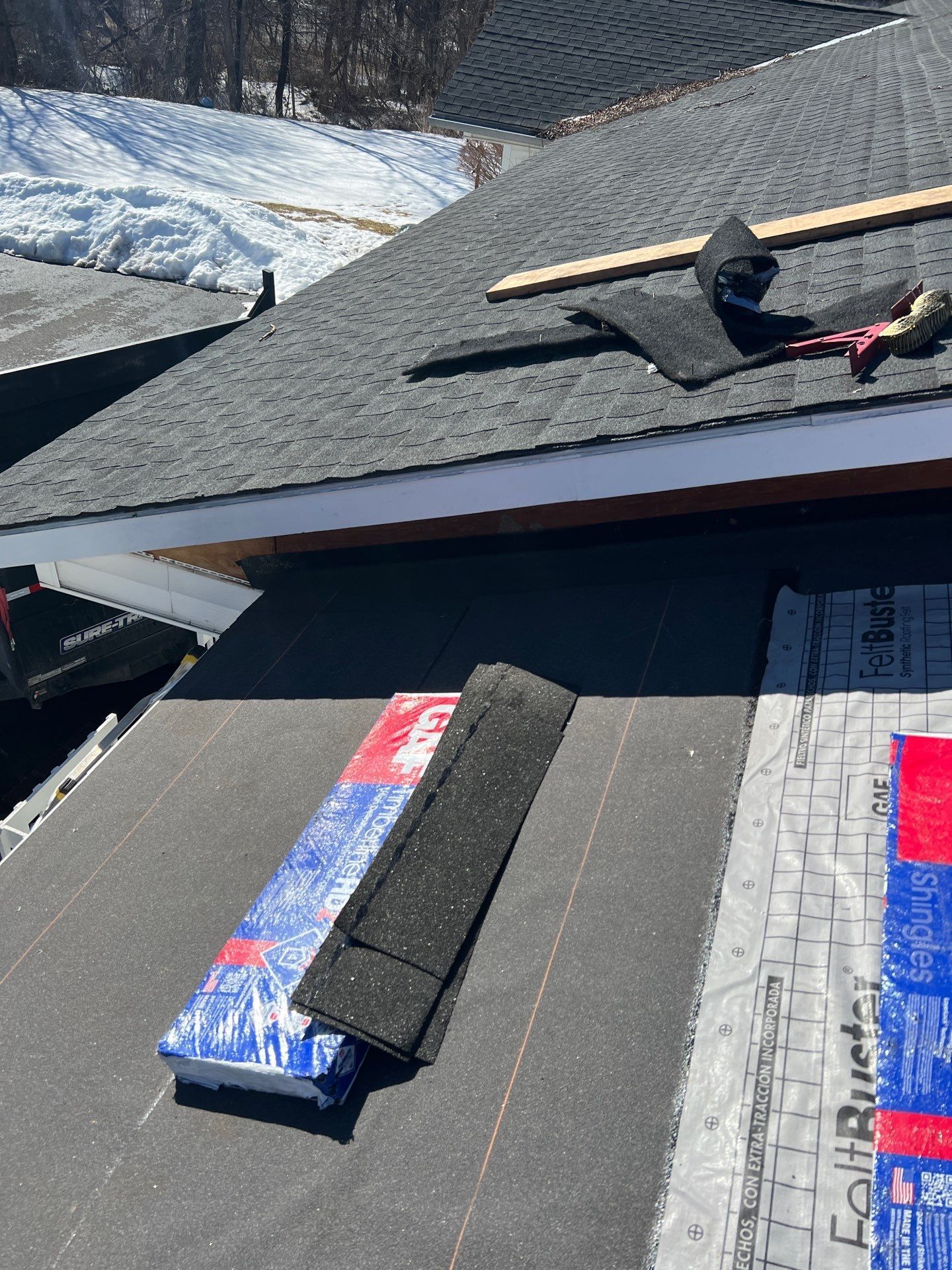 Close up of roof with shingles coming up that needs repair work
