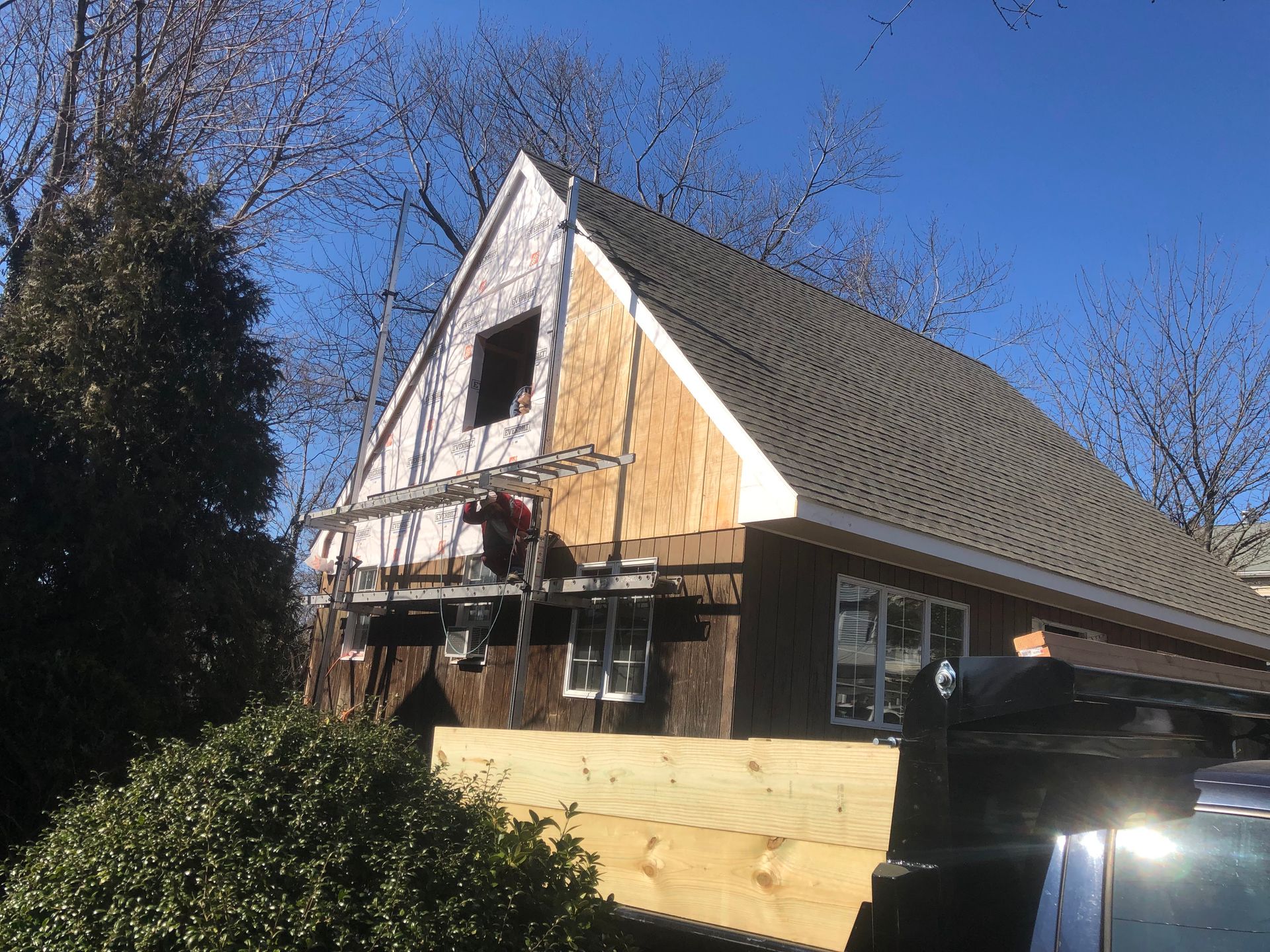 A house with a cedar roof being installed