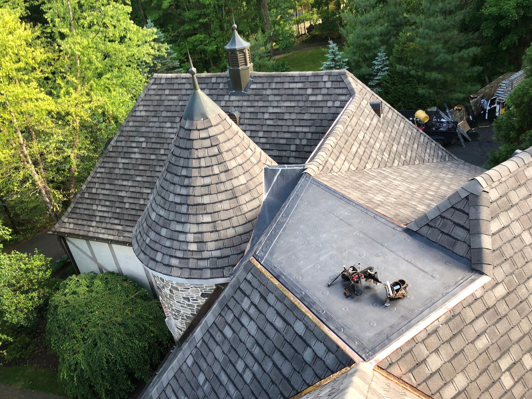 An aerial view of a roof of a house with a castle shaped roof being replaced