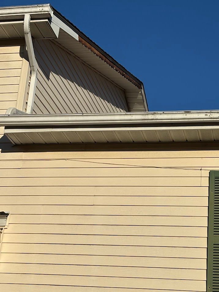 Side view of soffit and fascia hit by storm damage and being repaired