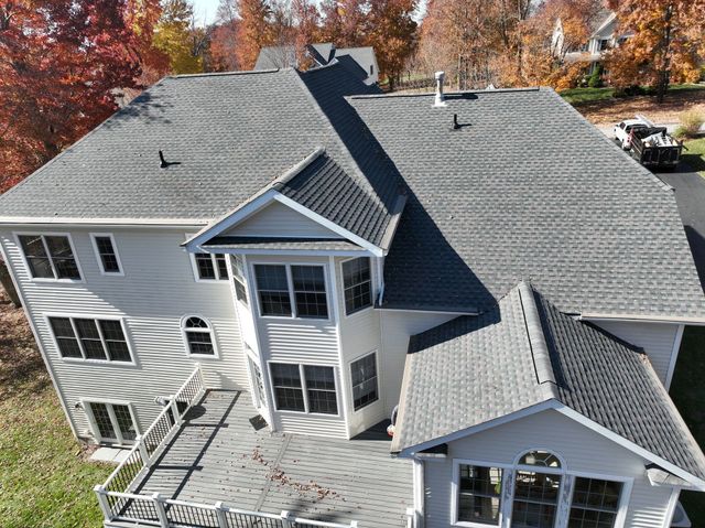 Large home with gray roof installation