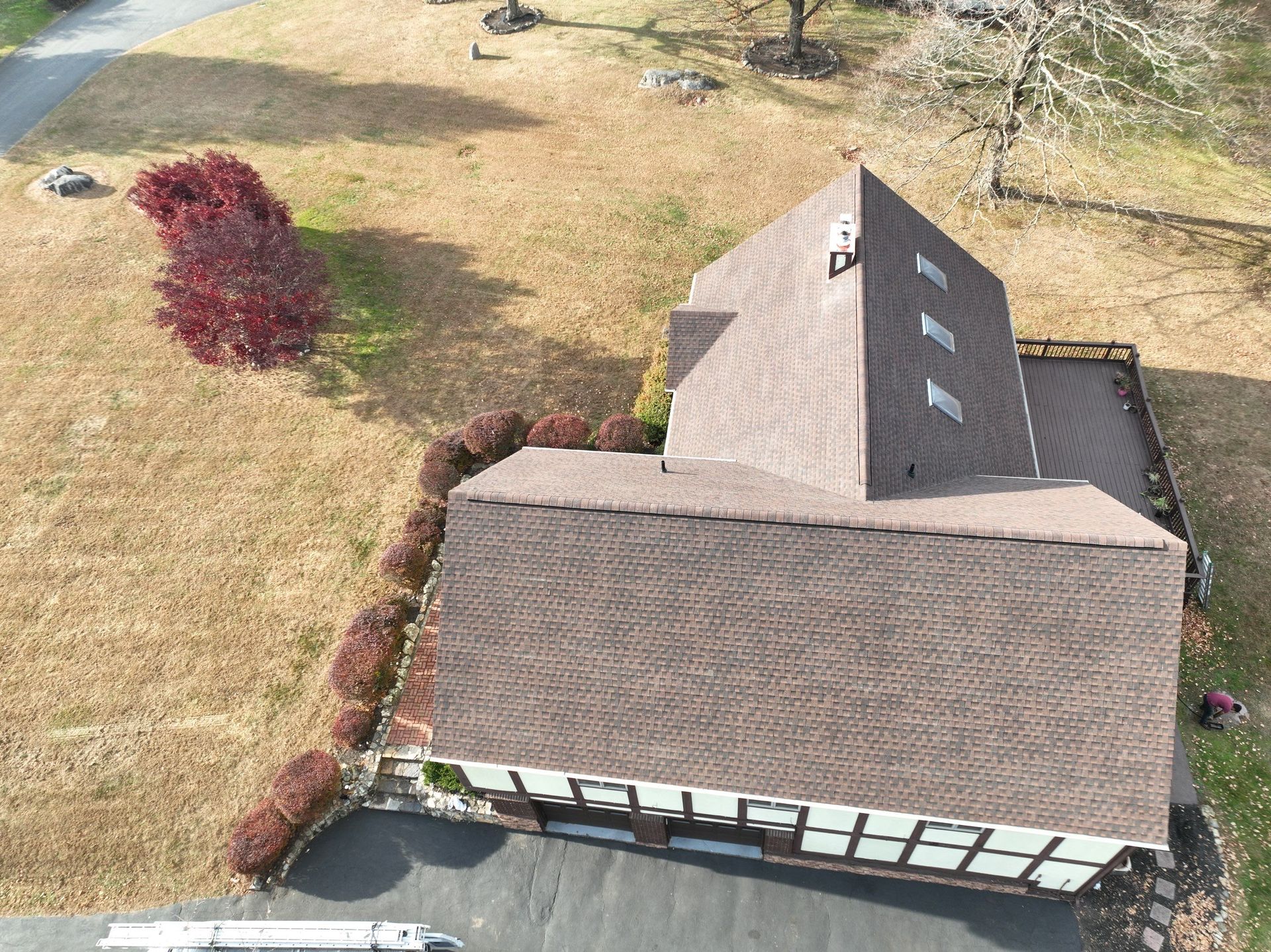 An aerial view of a house with a brown roof instalaltion