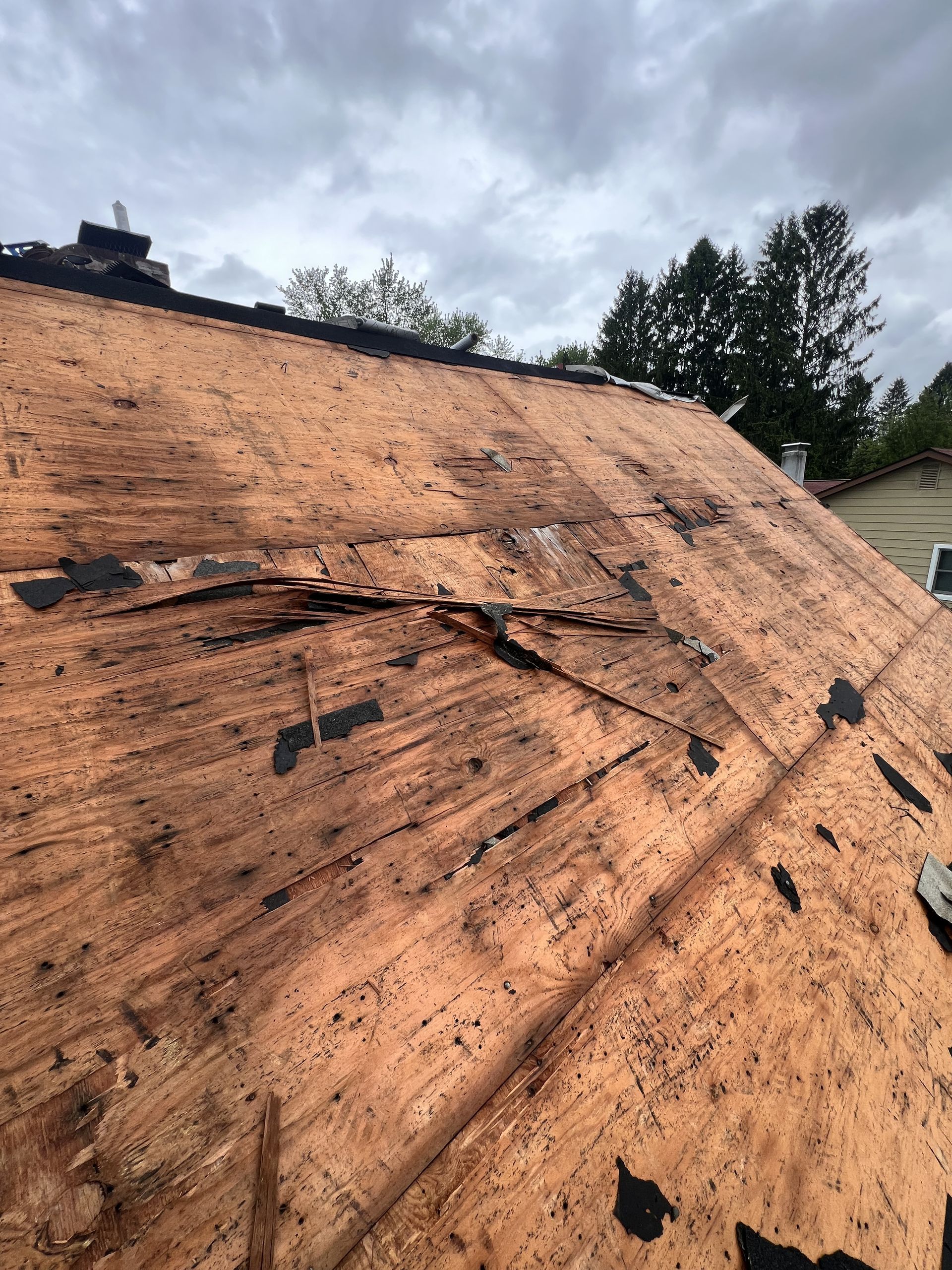A roof with a lot of damage on it is being repaired with roofing financing