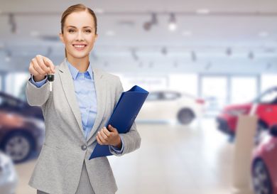 woman holding a paper and key