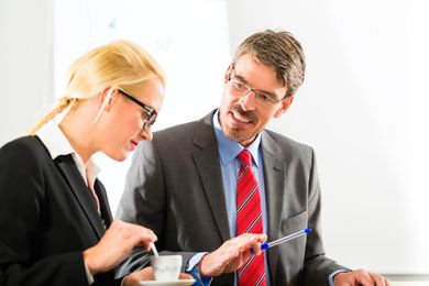 two people talking inside the office