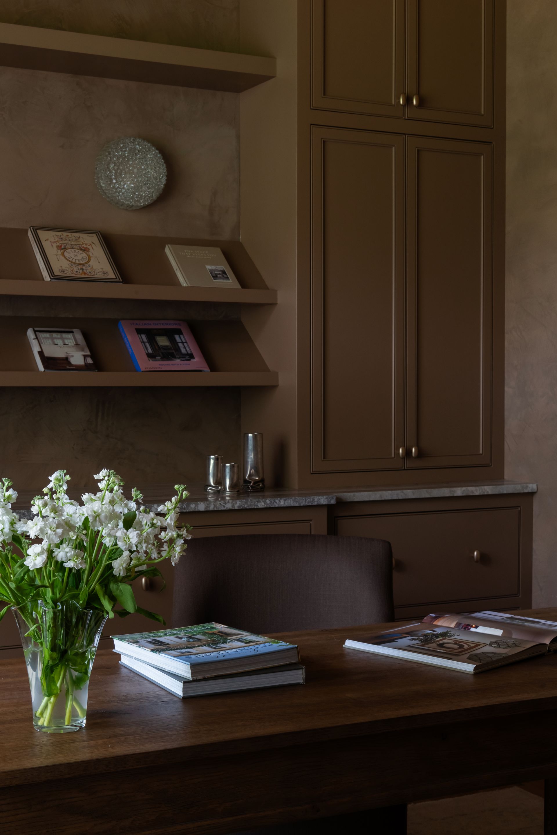 luxury interior designer in franklin, tn. featuring a custom office cabinetry with plaster walls and vintage lighting