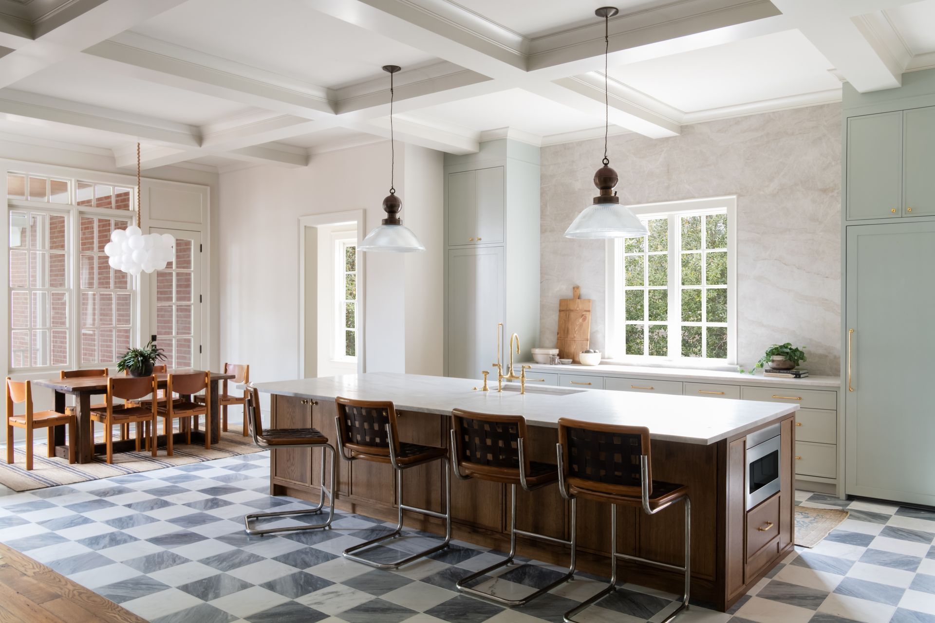 Luxury European inspired kitchen designed by nashville interior designer featuring taj mahal quartzite and white oak cabinets