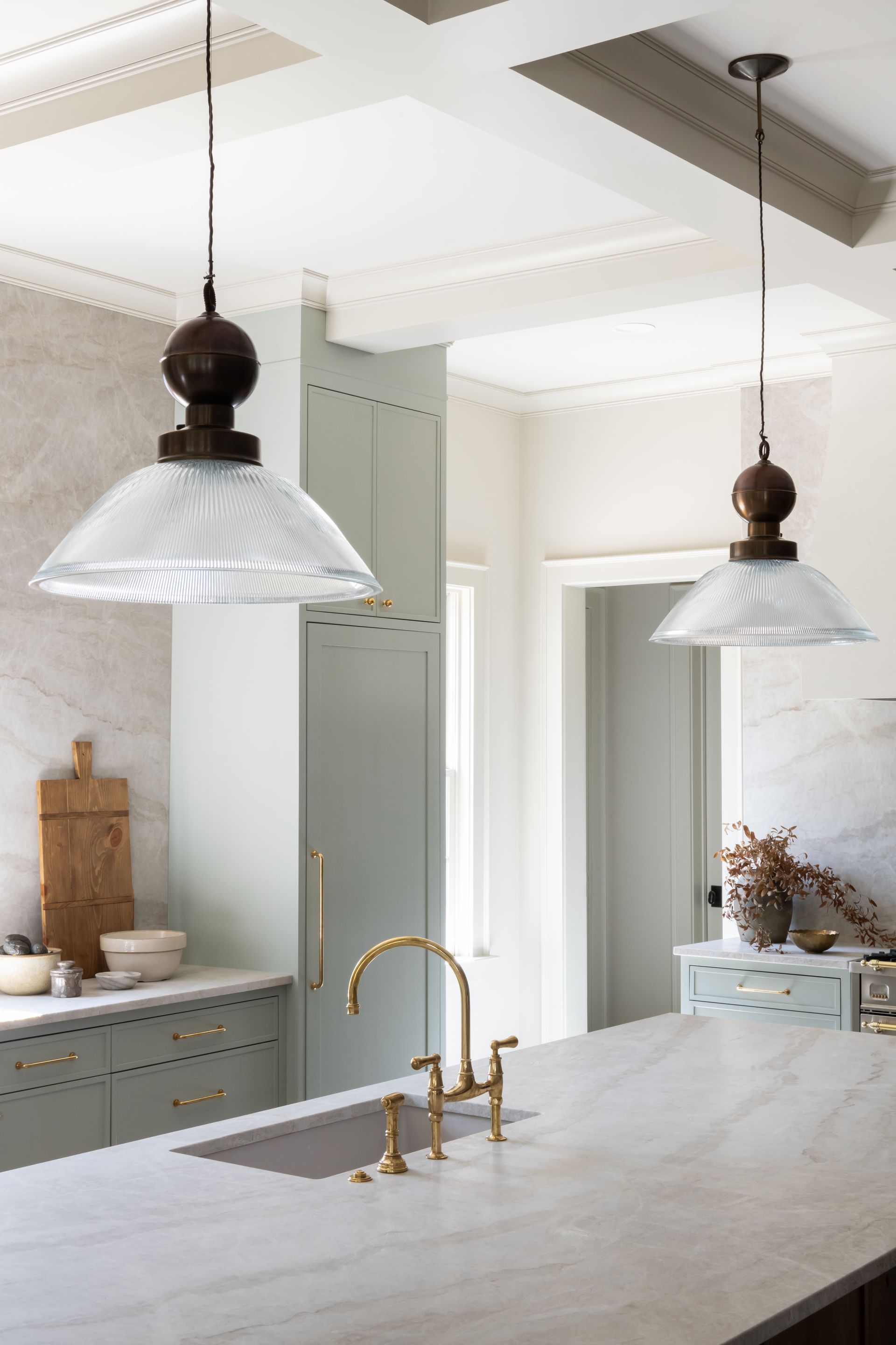 Luxury European inspired kitchen designed by nashville interior designer featuring taj mahal quartzite and white oak cabinets