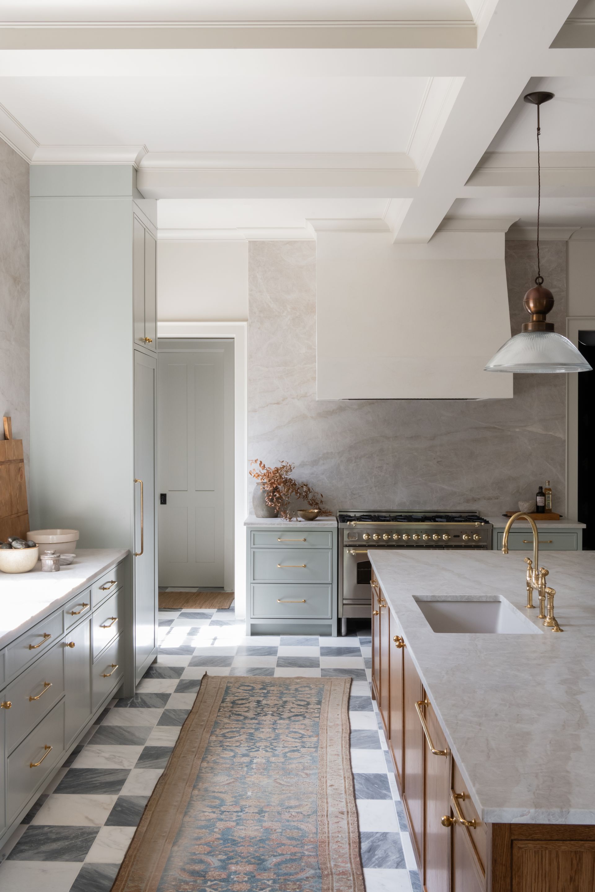 Luxury European inspired kitchen designed by nashville interior designer featuring taj mahal quartzite and white oak cabinets