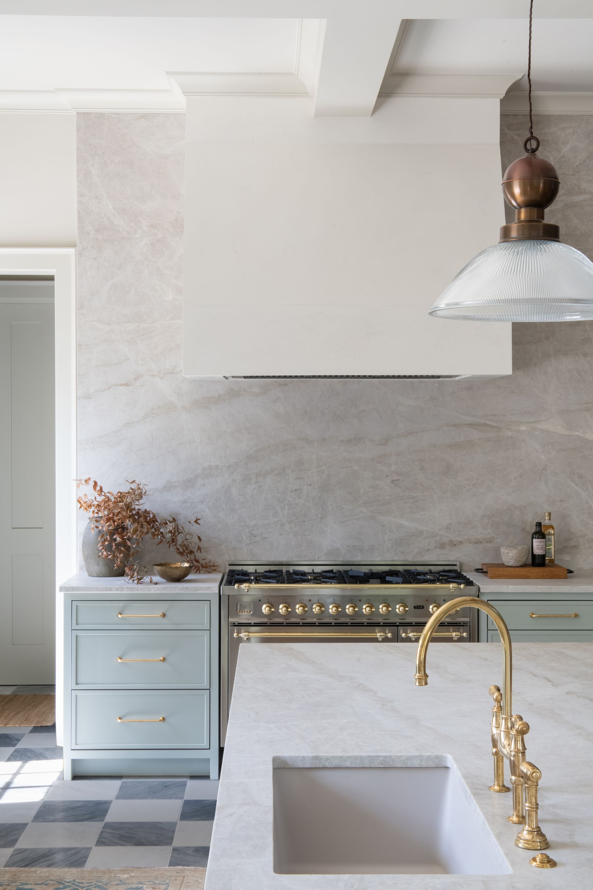 Luxury European inspired kitchen designed by nashville interior designer featuring taj mahal quartzite and white oak cabinets